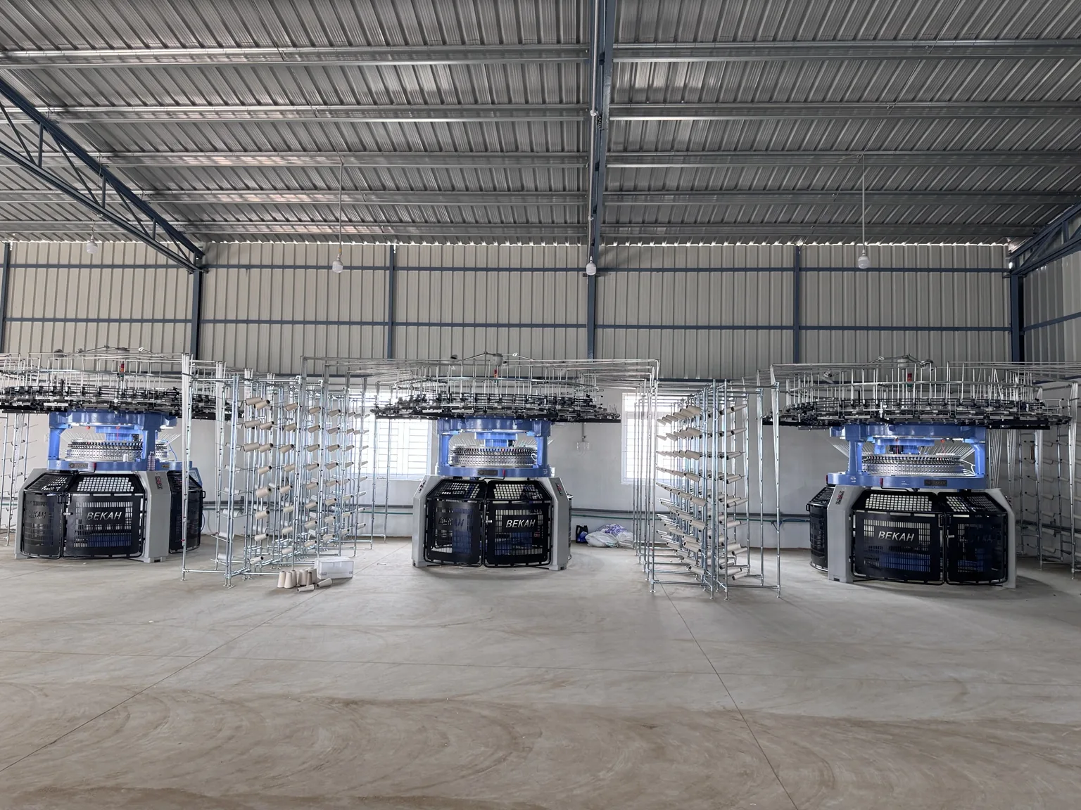 Kanik Fabrics factory floor with multiple Bekah circular rib knitting machines